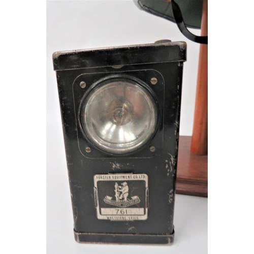 214 - Two Warwickshire Constabulary Helmets And Torch
dark blue, two piece crown.  Pointed peak and rounde... 