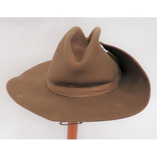 228 - WW2 Dated British Slouch Hat
khaki felt crown.  Wide brim turned up to the left side and secured by ... 