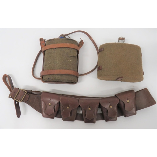 1903 Pattern Leather Bandolier And Two Waterbottles
consisting brown leather, five pouch bandolier.  South African made dated 42.  Together with a 1903 pattern leather waterbottle harness complete with felt covered, blue enamel waterbottle ... Alloy, Officer pattern waterbottle with green felt cover.  3 items.