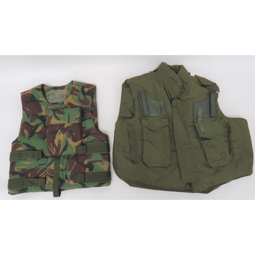 Two British Army Body Armour Vests
consisting 1960's pattern, green nylon covered vest.  Both shoulders with rubber rifle butt rests.  The faults with rectangular pockets.  Velcro fastened front ... Later DPM camouflaged example.  Velcro strap sides and front.  Heavy armoured panel to the chest.  2 items.