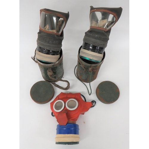 303 - Three Various WW2 British Respirators
consisting child's Mickey Mouse example with red rubber face p... 