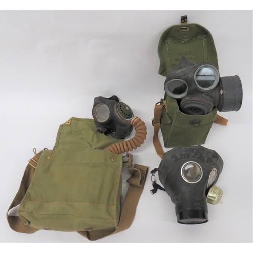 304 - Three Various British Respirators
consisting military corrugated hose example.  Black rubber fa... 