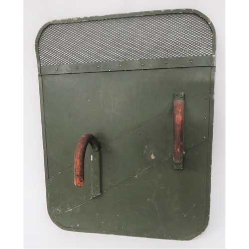 Early Post War British Army Riot Shield
green painted, rectangular alloy shield.  The top with mesh visor.  Rear fitted with leather covered arm hook and grip handle. 
As used in early Northern Ireland troubles.  