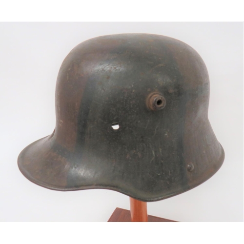 402 - Imperial German M1916 Camouflaged Battle Damaged Steel Helmet
steel crown with lower rolled edge bri... 