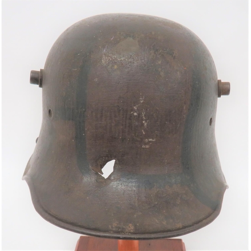 402 - Imperial German M1916 Camouflaged Battle Damaged Steel Helmet
steel crown with lower rolled edge bri... 