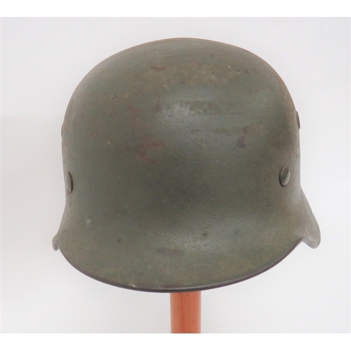 405 - Third Reich German Wehrmacht Combat Helmet
green painted steel shell with lower rolled edge brim.  I... 