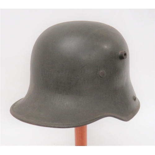 406 - Imperial German M1916 Combat Steel Helmet
green painted steel crown with lower rolled edge brim. &nb... 