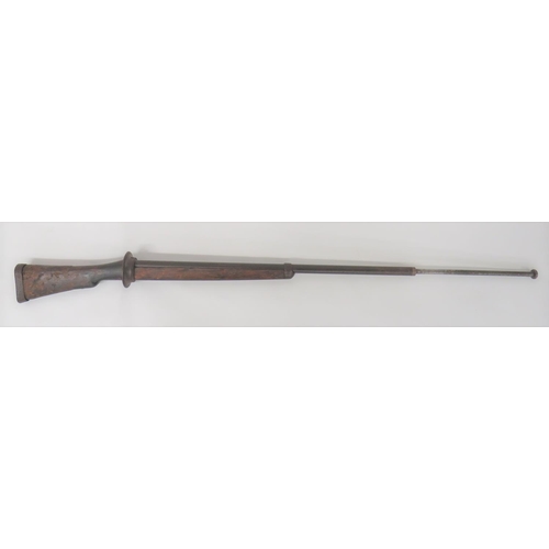 Scarce Late 19th Century Bayonet Practice Rifle
33 inch barrel with front sprung loaded rod plunger (spring absent).  Rear steel circular disk guard.  Steel strengthening tangs to the top and bottom of the wooden butt.  Steel butt cap.  Front woodwork with lower steel strengthening tang and front end securing cap.  Butt with some damage.  