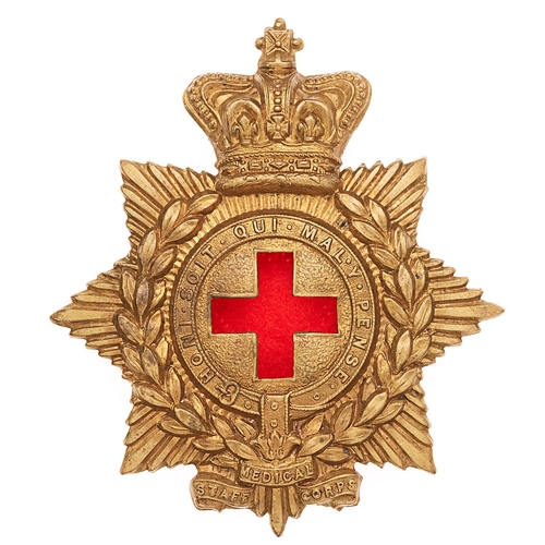 Medical Staff Victorian glengarry cap badge circa 1884-98.  Good scarce die-stamped brass crowned star bearing laurel sprays, Garter and tri-part title scroll; central voided Geneva Cross.    Brass loops.  VGC  Army Hospital Corps changed to Medical Staff Corps by Warrant of 20.9.1884.