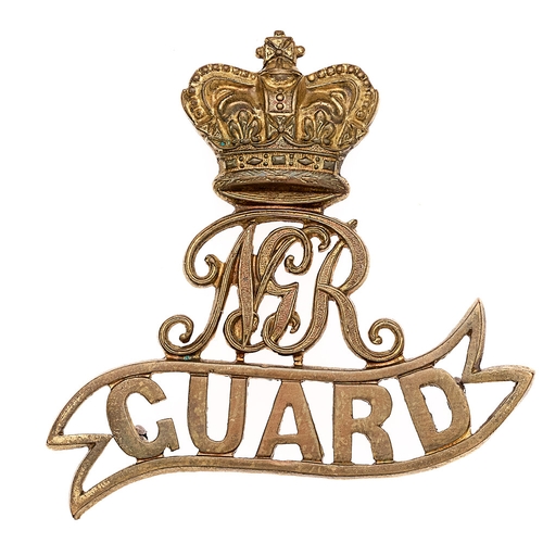 South Africa. Natal Government Railway Guard Victorian cap badge.  Good scarce die-stamped brass crowned NGR cypher on GUARD voided scroll. (Owen 502)    Three loops.  VGC