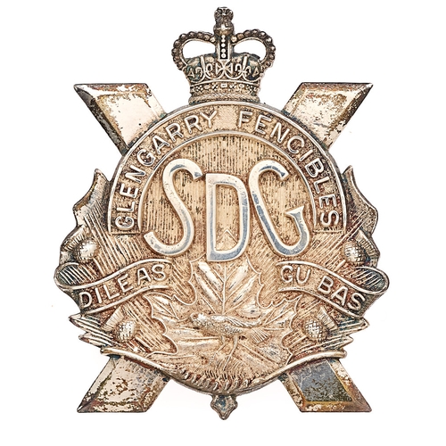 Canadian Stormont, Dundas and Glengarry Highlanders post 1953 Officer's silver head-dress badge.  Fine scarce Canadian Scottish die-cast saltire superimposed with crowned arched scroll GLENGARRY FENCIBLES with SDG below resting on Maple leaf, DILEAS GU BAS bi-part scroll, bird and thistle sprays. Reverse impress STERLING RMCO  BREADNER Co LTD HULL CANADA  Loops.  VGC  Landed in Normandy on D Day; first regiment to enter Caen.