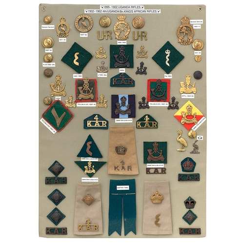 392 - 58 Uganda Rifles and 4th King's African Rifles badges etc.  Board with good display of metal and clo... 