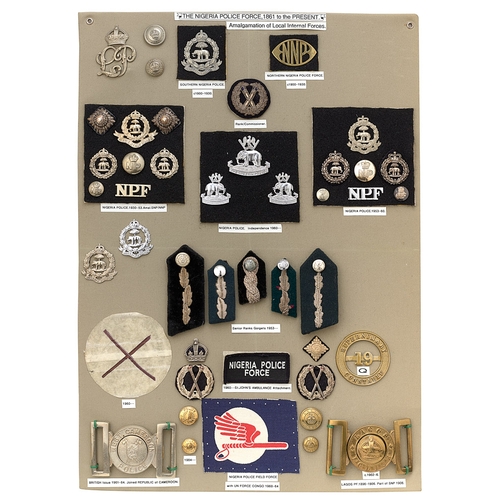 394 - 44 Nigeria Police badges etc.  Board with good display of metal and cloth badges, 2 waist belt clasp... 