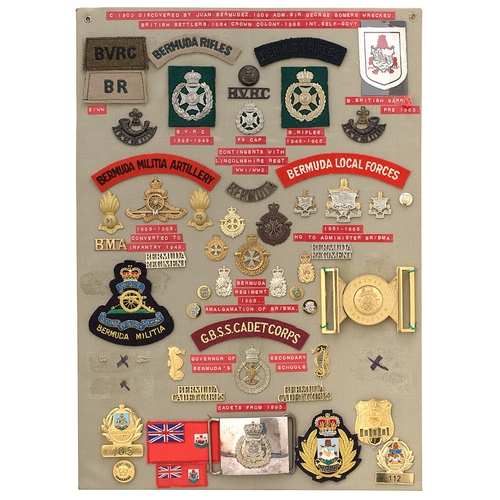 404 - 52 Bermuda military and police badges etc.  Board with good display of metal and cloth badges, 2 wai... 