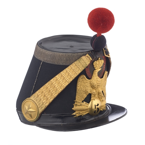 French 5th Infantry Officer's Mid 19th Century Shako.  A good example tailored in Paris Circa 1860. The black shako retaining fine gilt plate of the 5th Infantry Regiment and retaining gilt chin scales. The interior with leather sweatband and crimson silk lining. complete with wool ball pommel. Gilt bright and fresh moth to the back edge base. End section of leather chinstrap backing absent.