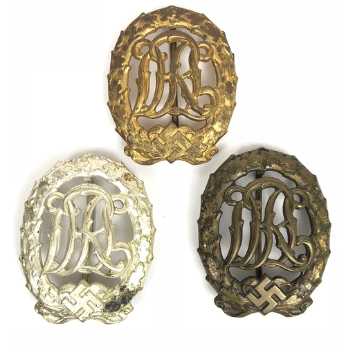 German Third Reich Gold, Silver and Bronze National Sports Badges by by Wernstein Jena  All three 1937 pattern die-cast by Wernstein, Jena and complete with hinged flat pin and securing hook. VGC (3 items)
