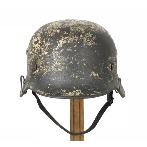 382 - German Third Reich Combat Steel Helmet.  This example with rolled edge example retaining traces of a... 