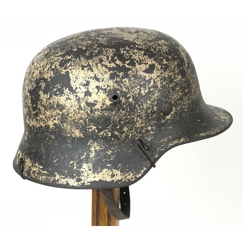 382 - German Third Reich Combat Steel Helmet.  This example with rolled edge example retaining traces of a... 