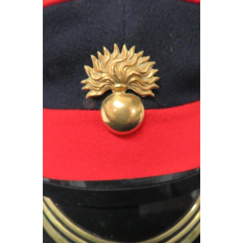 214 - Seven Various Guards Dress Caps
consisting dark blue with white band and piping Coldstream Guards ..... 