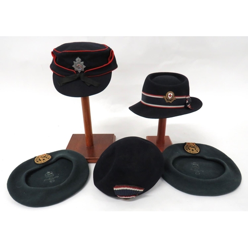 5 x Home Front Hats
consisting 2 x green WVS berets with embroidery QC Civil Defence Corps badges ... 1944 dated, Women's NFS dark blue cap with red piping. Chrome KC NFS badge ... Dark blue BRCS trilby hat with badge ... Dark blue BRCS soft hat with badge.  5 items.
