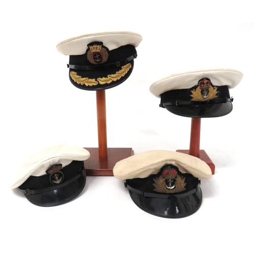 219 - Four Navy Officer Caps
consisting Merchant Navy Captain's example.  White top.  Black body... 