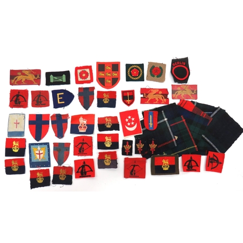 50 x Various Formation Badges
including embroidery Anti Aircraft Command ... Printed Anti Aircraft Command ... Printed British Troops In France ... Printed HQ Far East Land Forces ... Embroidery London District ... Bevo weave Berlin District ... Printed QC War Office ... Embroidery QC War Office ... Small selection of tartan patches. 