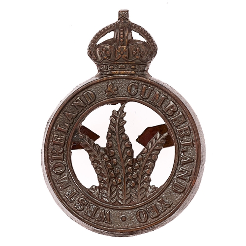 Badge. Westmoreland & Cumberland Yeomanry post 1908 OSD cap badge.  Good scarce die-stamped crowned title circlet; three sprigs of heather to voided centre.    Blades  VGC