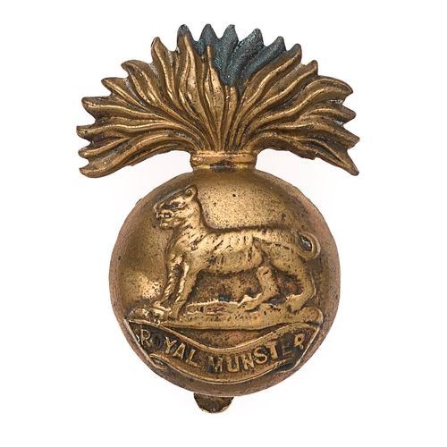 Badge. Irish. Royal Munster Fusiliers WW1 all brass economy cap badge circa 1916-18.  Good scarce die-stamped flaming grenade, the ball bearing Royal Tiger on ROYAL MUNSTER scroll.    .  Touch of verdigris. Service wear