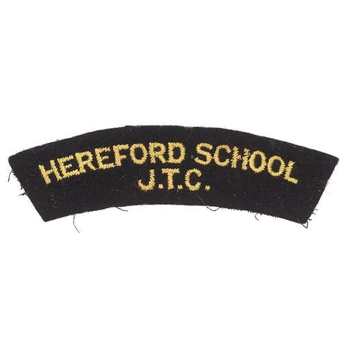Badge. HEREFORD SCHOOL / JTC  cloth shoulder title circa 1940-48.  Good scarce yellow embroidered on black.      GC