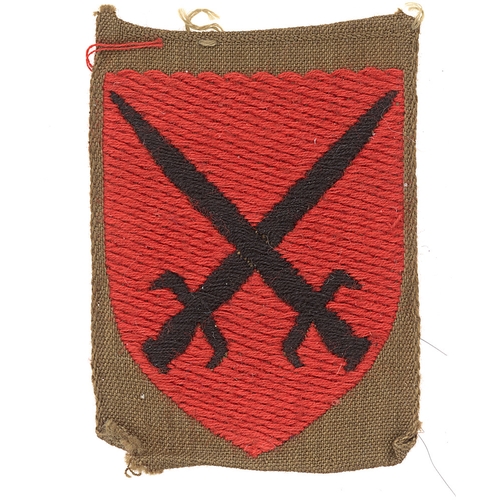 474 - Badge. 115th Independent Infantry Brigade WW2 formation sign.  Black crossed swords on red shield em... 