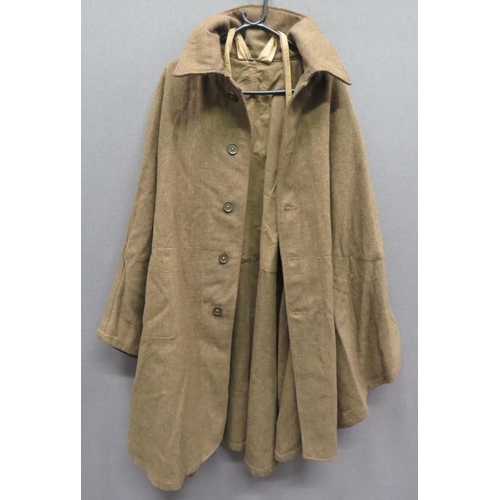 Scarce Home Guard Woollen Cape
khaki woollen, sleeveless cape.  Large fold over collar.  The front fastened by five composite buttons.  Two internal, open top patch pockets.  Khaki drill securing straps.  Issue label "Cape, Serge Home Guard" dated "Dec 1940".  Clean condition.  