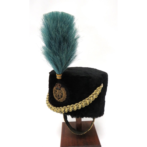 Post 1953 Royal Air Force Bandsman Busby
black, short fur body.  The front with bullion embroidery, QC RAF badge.  Gilt twisted cord swag secured by anodised buttons.  Blue horsehair plume.  Leather and velvet sweatband.  Brass chin chain with leather backing.  Clean condition.  