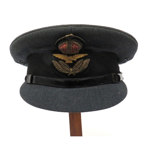 Pre 1952 Royal Air Force Officer's Service Dress Cap
blue grey crown, body and stiffened peak.  Black mohair band with bullion embroidery, KC Officer's cap badge.  Black patent leather chinstrap secured by two plain buttons.  Leather sweatband.  Crown with faint Gieves maker's label.  