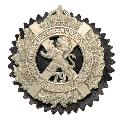 Canadian / Scottish. 79th Cameron Highlanders of Canada feather bonnet badge.  Good scarce large, approx 73 mm,  die-stamped crowned title circlet on saltire set in a thistle and maple sprays bearing scroll ULLAMH; on the saltire, rampant lion with 79 below. Black patent leather pinked edge rosette.    Loops.  VGC