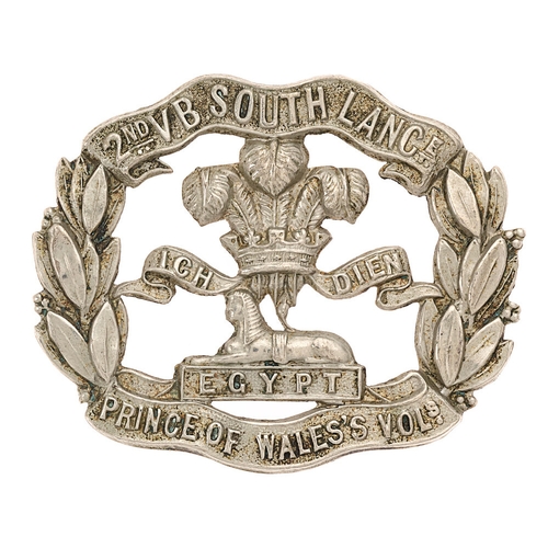 2nd (St. Helens) VB South Lancashire Regiment cap badge circa 1896-1908.   Good scarce die-stamped white metal title scrolls joined by laurel sprays; Prince of Wales's plumes over Sphinx on EGYPT to voided centre    Toned loops.  VGC