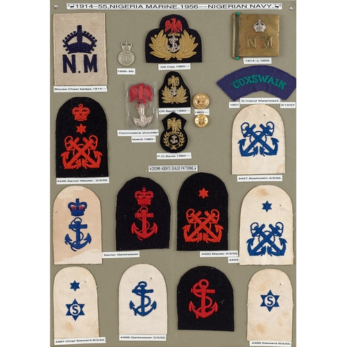 294 - Nigeria approx. 20 badges etc.  Board with good display of metal and cloth badges, buttons, waist be... 