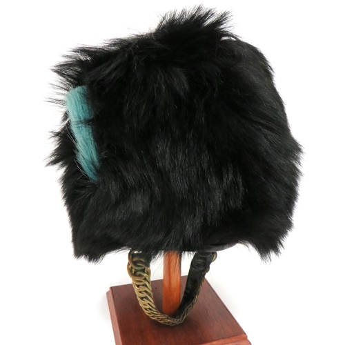 178 - Irish Guards Busby
black, long fur busby.  The right side with light blue, short horsehair plum... 