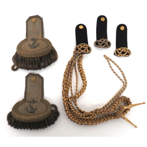 230 - Royal Navy Aiguillettes And Shoulder Boards
consisting gilt and blue cord aiguillette with gilt and ... 