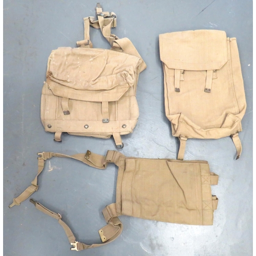 Three 1937 Pattern Webbing Equipment Carriers
consisting khaki webbing, open top pack for cartridges box. Rear padded panel.  L type straps.  Dated "44" .... Khaki webbing large pack dated 1944 ... Khaki webbing, double compartment pack.  Internal fibre board base.  Rear of pack with padded panels.  L type straps.  Flap dated 1942.  3 items.