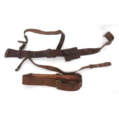 263 - 2 x Officer Sam Browne Belts
consisting brown leather belts with brass buckles and fittings.  B... 