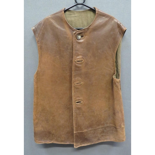 313 - WW2 Dated Leather Jerkin
brown leather, multi panel, sleeveless jerkin.  The front fastened by ... 