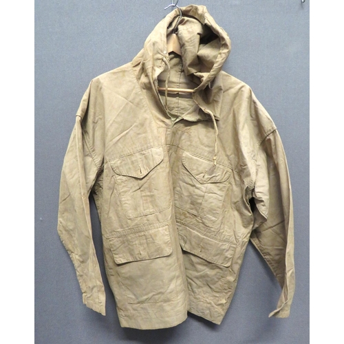 WW2 Sand Pattern Windproof Smock
sand colour cotton, pull over smock.  Top hood with tightening cord.  Pleated chest pockets and lower patch pockets, all with buttoned flaps.  Base with provision for a tightening cord.  Neck opening with stitching faults.  Some minor service wear.  