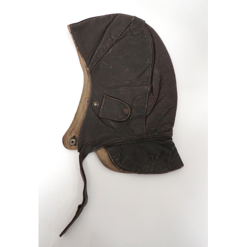 WW1/Interwar Continental Flying/Driving Helmet
dark brown chrome leather, multi panel crown and neck flap.  Small, side ear flaps secured by single press studs.  Leather crown strap.  Leather chinstrap.  Internal cotton lining.  Some wear.  