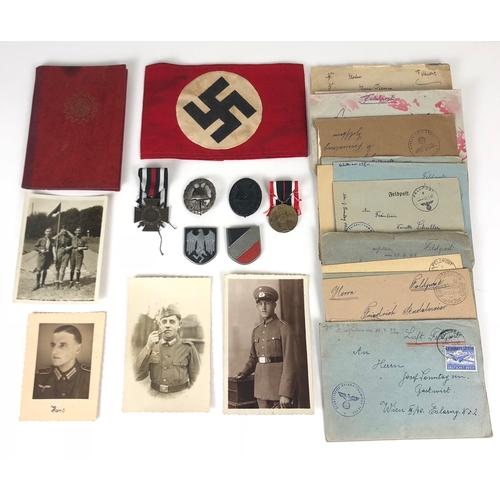 German Third Reich NSDAP armband, photographs, WW2 Feldpost letters, badges and medals.  Red linen armband with applied white disc bearing printed swastika ... DAF ID booklet ... various photos of military personnel ... WW2 Feldpost letters ... Hindenburg Cross for combatants ... WW1 voided Wound Badge ... 1939 black Wound Badge ... 1939 War Merit Medal and a pair of pressed aluminium painted Afrika Korps decals complete with fixing pins.      Minor service wear. GC