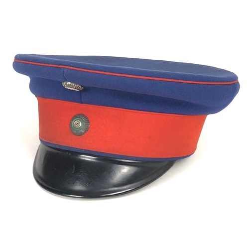 Imperial German WW1 Saxon Infantry Officer's peaked cap or Schirmmutze.  Fine scarce example with blue woollen body and crown, the latter piped in red; red cap band and pressed black fibre peak. The front retaining red, white and black cockade over another of silver, green, silver. White cotton lining and faux leather cream sweatband. VGC