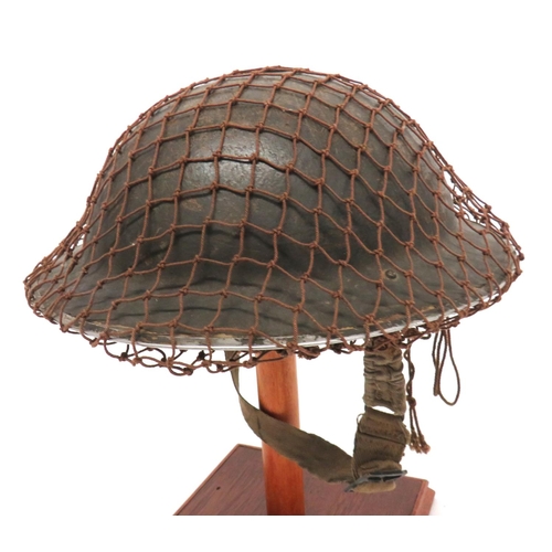 178 - WW2 British MKII Steel Helmet And Camo Net
green painted outer shell.  Inner brim with maker da... 