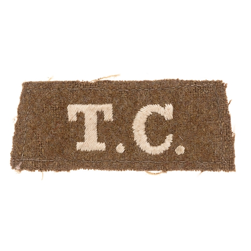 243 - T.C. WW1 Tank Corps slip-on cloth shoulder title.   Good scarce white embroidered letters on khaki f... 