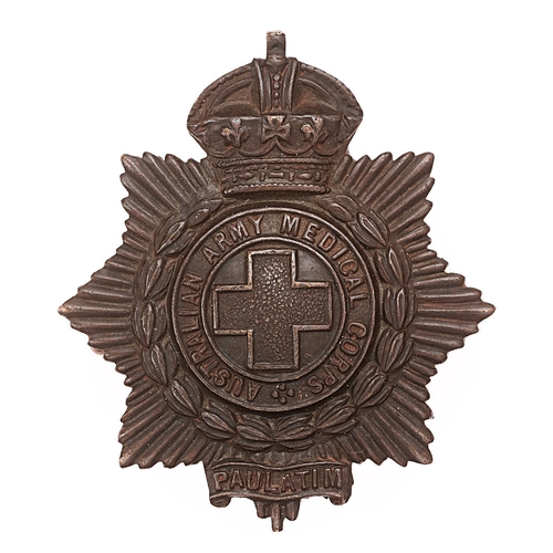 Australian Army Medical Corps c. 1900-12 cap badge.  Good scarce die-stamped bronze crowned star bearing title circlet resting in laurel sprays with central Geneva Cross; PAULATIM scroll across the lowest point.    Loops.  VGC