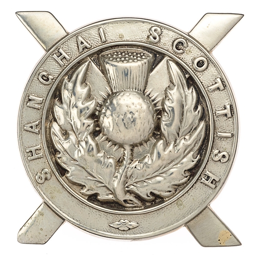 China. Shanghai Scottish glengarry badge c. 1914-41.  Good scarce British made die-stamped white metal title circlet with central thistle superimposed on saltire.    Loops.  Service wear. GC  Bob Betts Collection