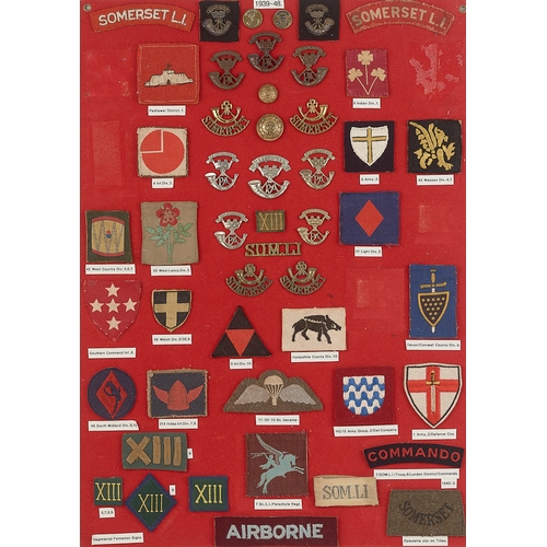 294 - Somerset Light Infantry badges and associated formation signs.  Board with interesting display of ap... 